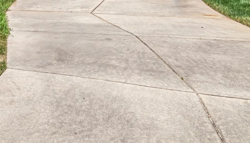 Concrete driveway with dirt and stains before pressure washing